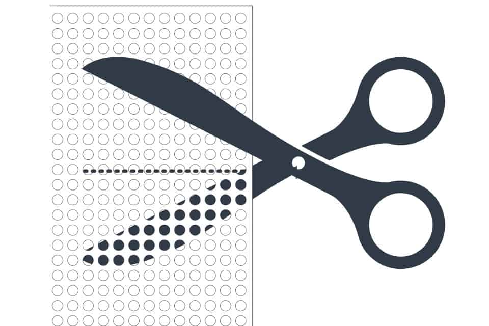 Cut perforated plastic or plastic canvas along the holes for cross stitch.