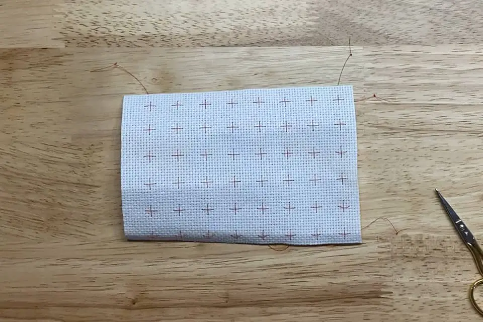 a piece of 14ct white aida cloth gridded with Easy Count Guideline